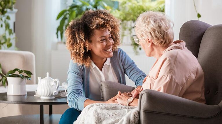 Nurse talking with a senior woman at home